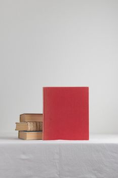 Stack of old rustic vintage books on white table