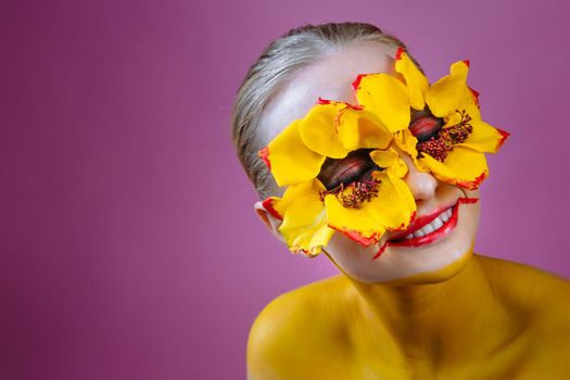 Girl model with yellow flowers around her eyes. Flower Girl