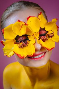 Girl model with yellow flowers around her eyes. Flower Girl