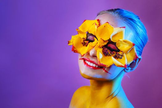 Girl model with yellow flowers around her eyes. Flower Girl