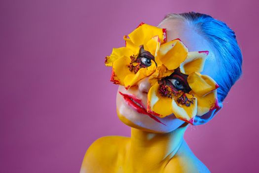 Girl model with yellow flowers around her eyes. Flower Girl