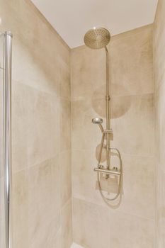 The luxury shower cabinet with brown tiled wall