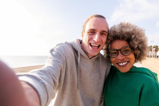 selfie of a happy young couple smiling funny, concept of friendship and fun in a relationship, copy space for text