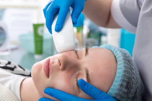 Young woman receiving electric galvanic anti-aging face spa massage at beauty salon. Galvanic massage helps to speed up metabolism, improve regeneration and restore skin protection from harmful external factors.