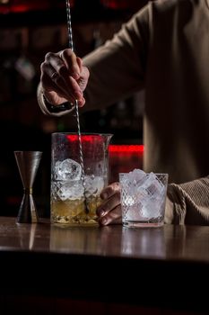Barman make alcohol cocktail at bar counter. Barman making Jungle Juice coctail in bar