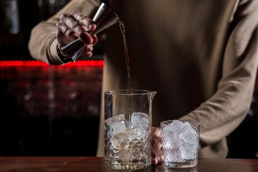 Barman make alcohol cocktail at bar counter. Barman making Jungle Juice coctail in bar