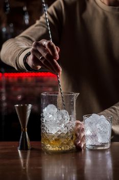 Barman make alcohol cocktail at bar counter. Barman making Jungle Juice coctail in bar