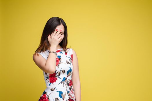 Waist up portrait of surprised beautiful girl with nice long hair, perfect makeup and fashion manicure. She is looking at camera with astonishment. Isolated on dark background