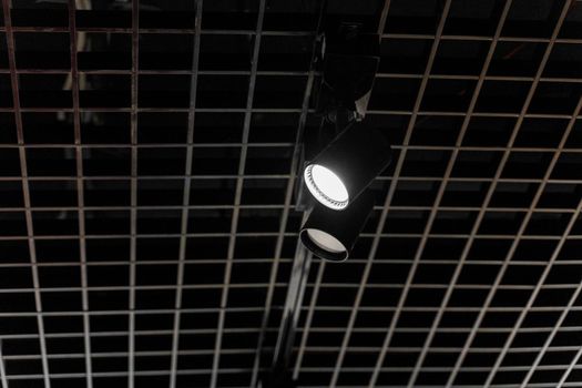 Lights system on dark ceiling of the office industrial black building, exhibition hall with led smart light. Ceiling construction