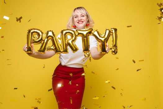 Fashionable womancelebrating a party event having fun and smiling with balloons