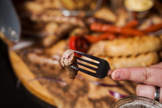 Barbecue grilled hot dog with yellow mustard and ketchup on wooden background. Hot dog sandwich with potato fries and sauces.