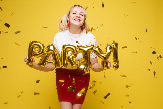 Fashionable womancelebrating a party event having fun and smiling with balloons