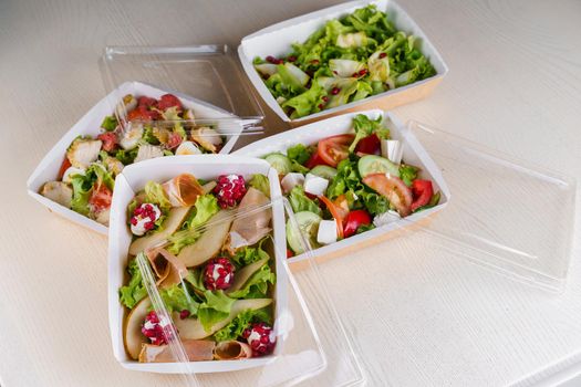 4 Green natural salads in eco thermo box with microgreen, veal, cucumber, tomato, cheese, garnet, peal. Safety delivery at quarantine covid 19