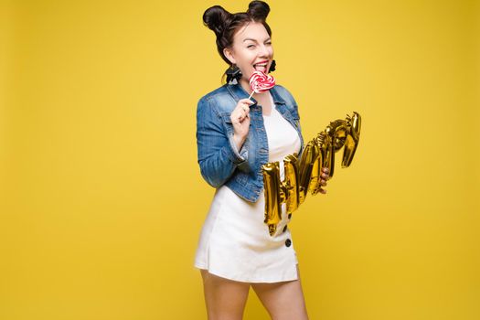 Fashionable womancelebrating a party event having fun and smiling with balloons