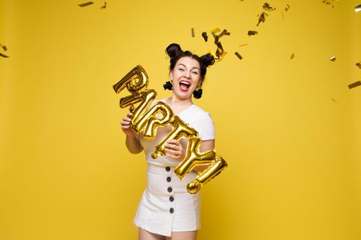 Fashionable womancelebrating a party event having fun and smiling with balloons