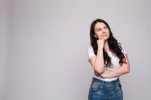 Portrait of happy fashion female with nice hairstyle and beautiful blue eyes posing at studio. Cheerful girl looking away and smiling. Isolated