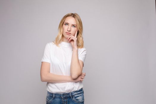 Portrait of happy fashion female with nice hairstyle and beautiful blue eyes posing at studio. Cheerful girl looking away and smiling. Isolated