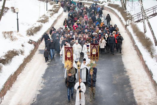 A crowd of people makes a religious procession