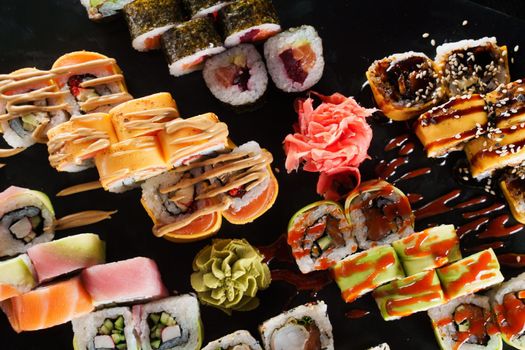 Sushi set on black background. Traditional Japanese seafood. Delicious roll. Advert for food delivery service