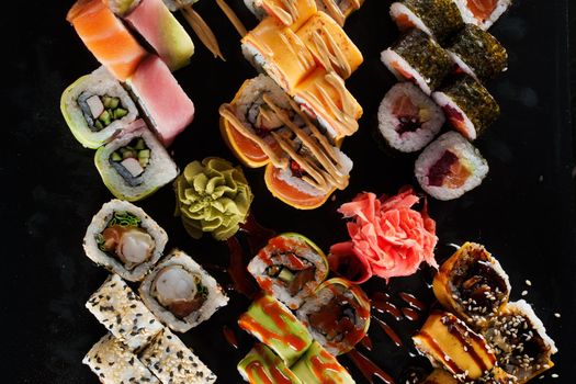 Sushi set on black background. Traditional Japanese seafood. Delicious roll. Advert for food delivery service