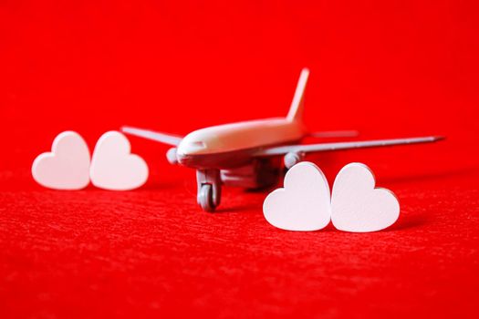 Hearts and a plane on a red background. Valentine's Day. Selective focus. Valentine.