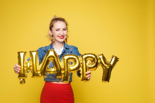 Fashionable womancelebrating a party event having fun and smiling with balloons