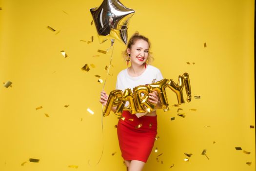 Fashionable womancelebrating a party event having fun and smiling with balloons