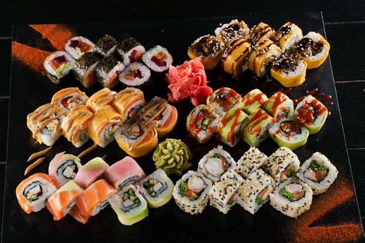 Sushi set on black background. Traditional Japanese seafood. Delicious roll. Advert for food delivery service