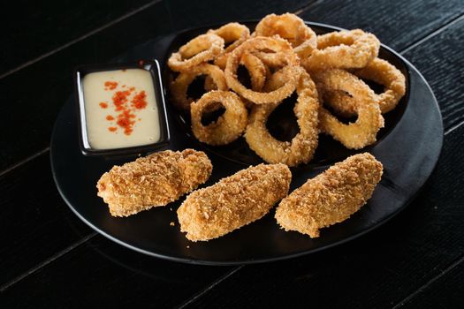 Beer snacks. Breaded meat appetizer and onion rings.