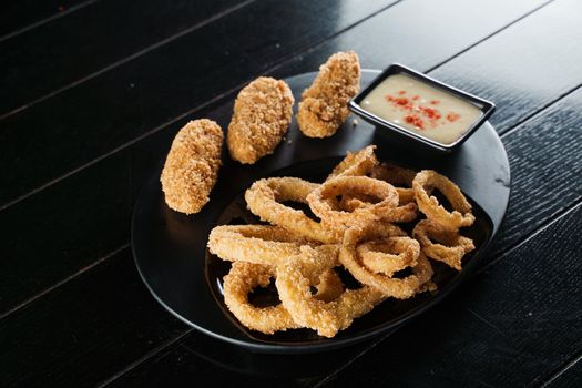 Beer snacks. Breaded meat appetizer and onion rings.