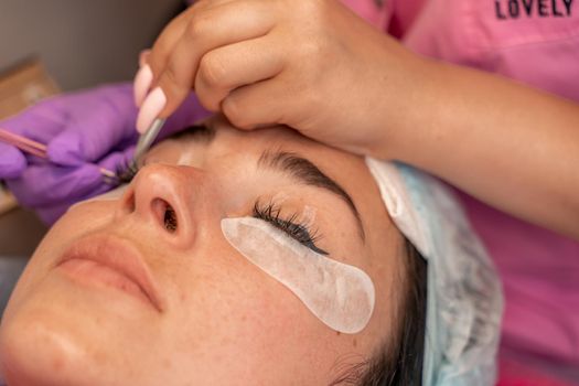 Eyelash extension procedure. Woman eye with long eyelashes. lashes, close up, macro, selective focus