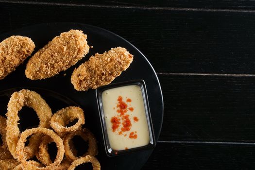 Beer snacks. Breaded meat appetizer and onion rings.