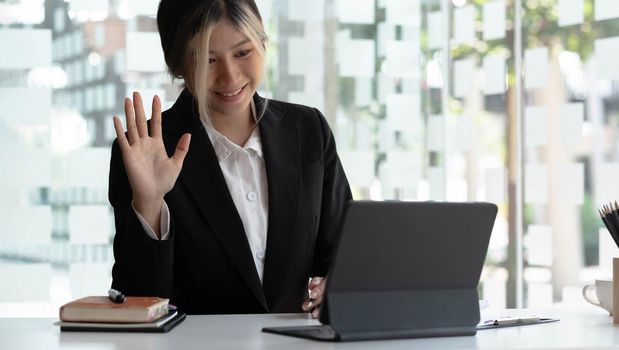 Video presentations conference young Asian businesswoman presenting presentations using video call at office..