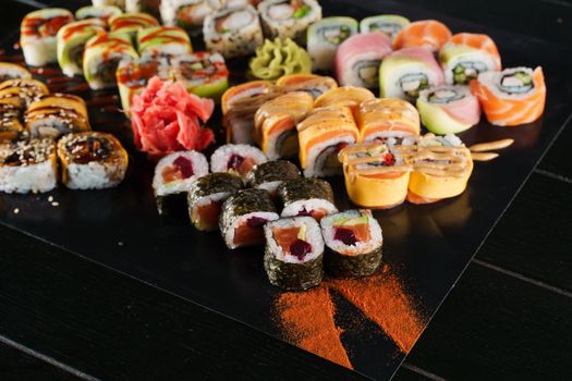 Sushi set on black background. Traditional Japanese seafood. Delicious roll. Advert for food delivery service