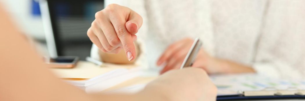 Focus on gorgeous female explaining every complicated detail of important business contract that can highly increase corporation profit. Company meeting concept. Blurred background