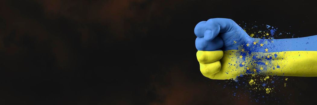 Accession of Ukraine to the European Union.The concept of Ukraine's accession to the EU.The fist is painted in the colors of the Ukrainian flag of blue and yellow with the flag of the European Union.