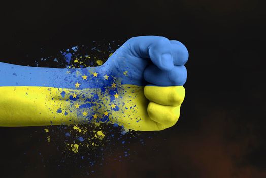 Accession of Ukraine to the European Union.The concept of Ukraine's accession to the EU.The fist is painted in the colors of the Ukrainian flag of blue and yellow with the flag of the European Union