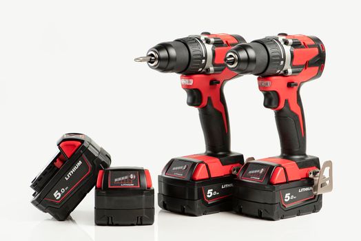 Drill. Set of cordless drills on a white background. Tool for drilling and making holes. Screwdriver set with high capacity spare batteries