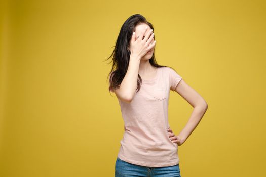 Waist up portrait of surprised beautiful girl with nice long hair, perfect makeup and fashion manicure. She is looking at camera with astonishment. Isolated on dark background