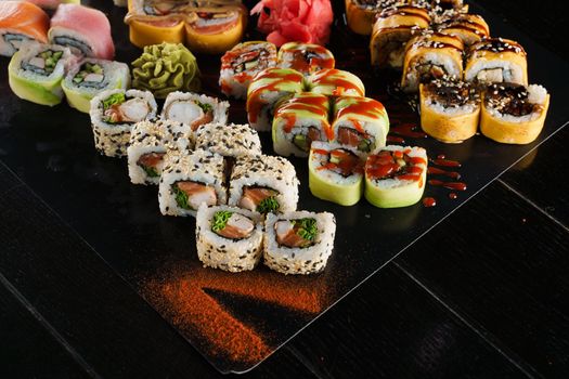 Sushi set on black background. Traditional Japanese seafood. Delicious roll. Advert for food delivery service