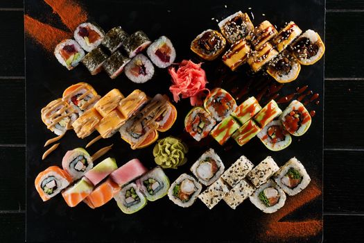 Sushi set on black background. Traditional Japanese seafood. Delicious roll. Advert for food delivery service