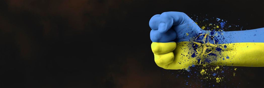 Ukraine's accession to the NATO military alliance. The concept of Ukraine's accession to NATO. The fist is painted in the colors of the Ukrainian flag in blue and yellow on a dark background