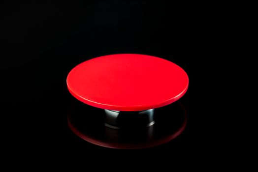 Big red button on a black background. The concept of the use of nuclear, biological or chemical weapons.