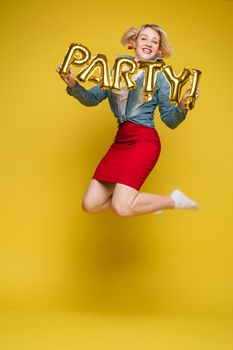 Fashionable womancelebrating a party event having fun and smiling with balloons