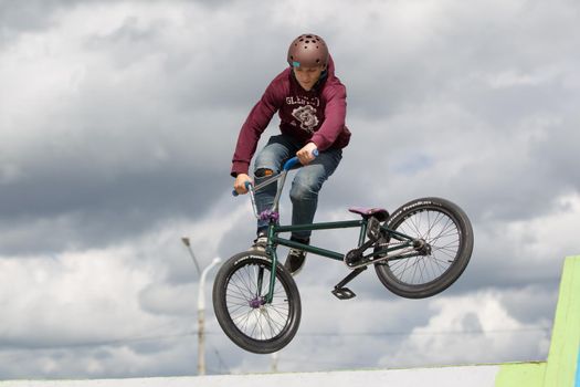 Extreme cycling.A man on an extreme bicycle against the sky. Leap into the sky