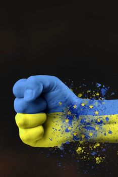 Accession of Ukraine to the European Union.The concept of Ukraine's accession to the EU.The fist is painted in the colors of the Ukrainian flag of blue and yellow with the flag of the European Union