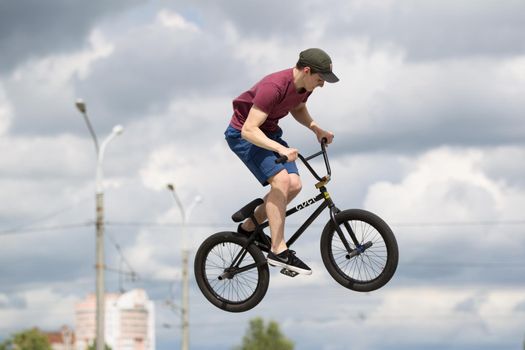 Extreme cycling.A man on an extreme bicycle against the sky. Leap into the sky