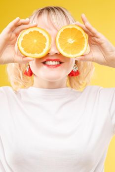 Portrait of a cool cheerful woman girl with oranges. Juice ads. Positive, harmony.