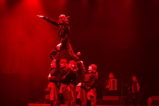 Belarus, Gomel, February 27, 2018. Concert hall. Speech of the national Georgian ballet Sukhishvili.Georgian dancers performing red-lighted dance on stage
