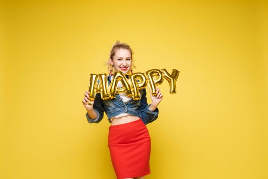 Fashionable womancelebrating a party event having fun and smiling with balloons